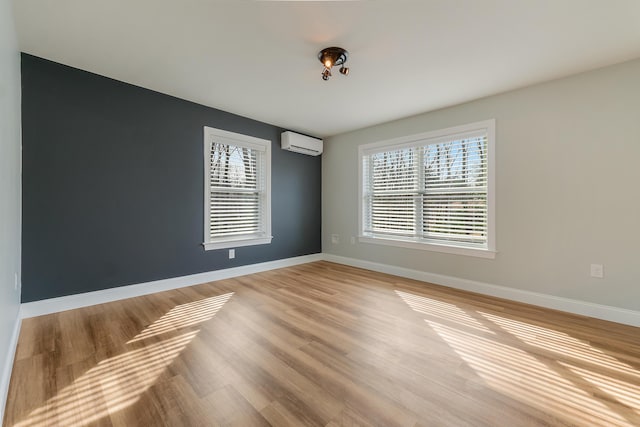 56 Old Kings Hwy, Ogunquit, ME 03907 - empty room featuring an AC wall unit, baseboards, and light wood-type flooring