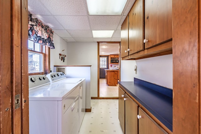 laundry area featuring cabinet space, washing machine and dryer, and light floors