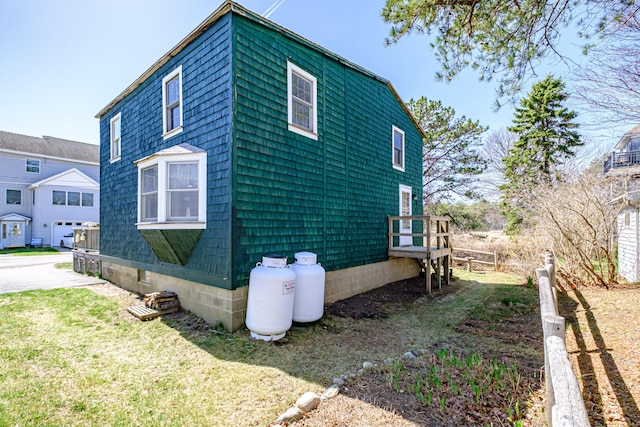 view of property exterior with a lawn