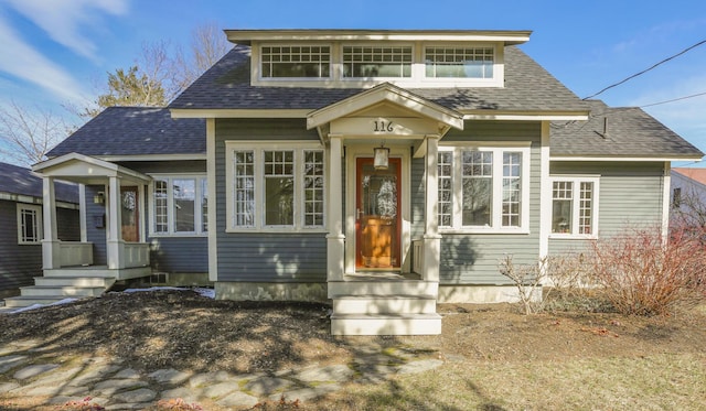 bungalow-style home with a shingled roof