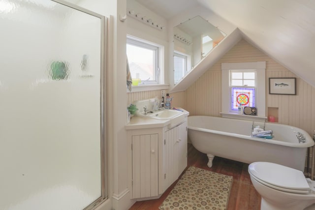 bathroom with a freestanding tub, vanity, vaulted ceiling, wood finished floors, and a stall shower
