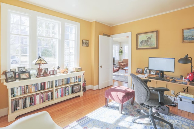 home office featuring baseboards, crown molding, and wood finished floors