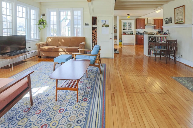 living room with beam ceiling and light wood finished floors