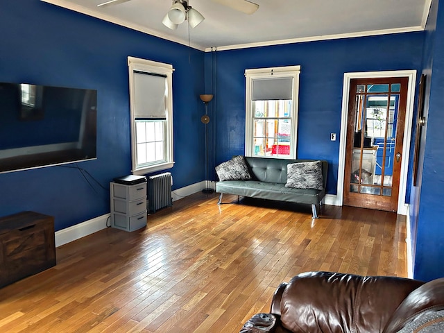 106 Northern Ave, Augusta, ME 04330 - living area featuring wood-type flooring, baseboards, a ceiling fan, and radiator