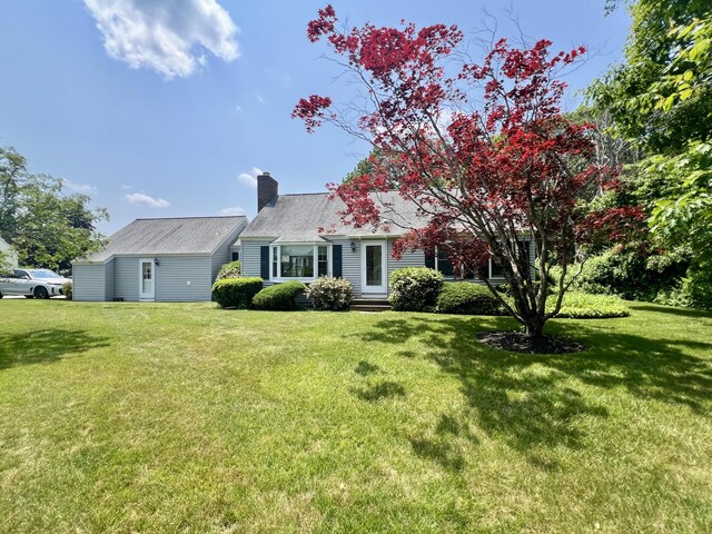 270 Meadowlark Vlg Unit 305, Ogunquit, ME 03907 - cape cod house featuring a front yard, a chimney, and entry steps