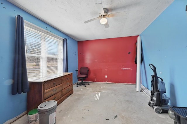 unfurnished office featuring unfinished concrete flooring and a ceiling fan