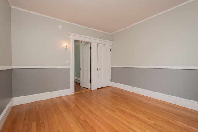 369 Ohio St, Bangor, ME 04401 - spare room featuring wood-type flooring, baseboards, crown molding, and a baseboard radiator