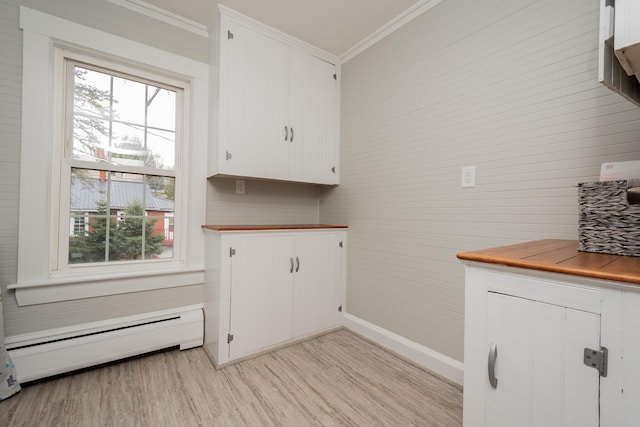 369 Ohio St, Bangor, ME 04401 - laundry area with baseboard heating, crown molding, light wood-type flooring, baseboards, and wooden walls