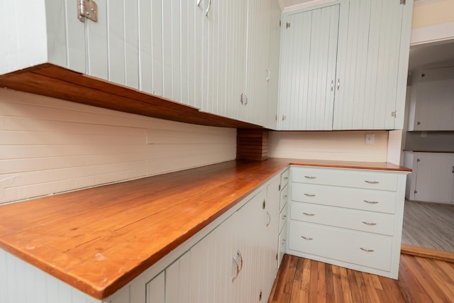 369 Ohio St, Bangor, ME 04401 - kitchen featuring light wood-type flooring, wooden counters, and white cabinetry