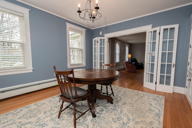 369 Ohio St, Bangor, ME 04401 - dining room featuring french doors, wood finished floors, a chandelier, and crown molding