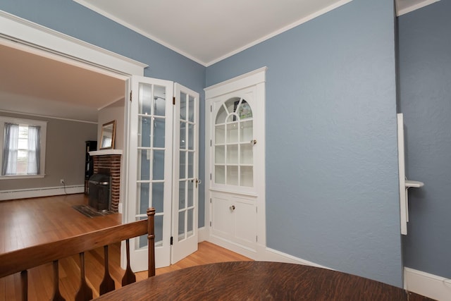 369 Ohio St, Bangor, ME 04401 - doorway to outside featuring a baseboard heating unit, ornamental molding, and wood finished floors