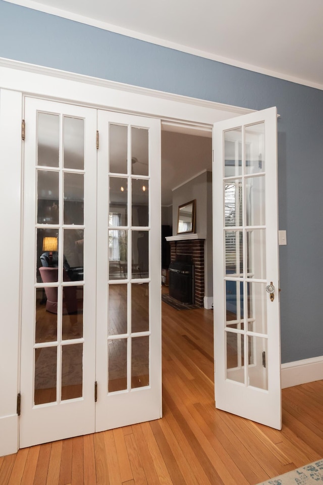 369 Ohio St, Bangor, ME 04401 - doorway to outside with french doors, a fireplace, and wood finished floors