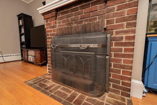 369 Ohio St, Bangor, ME 04401 - detailed view of wood finished floors, a baseboard radiator, and crown molding