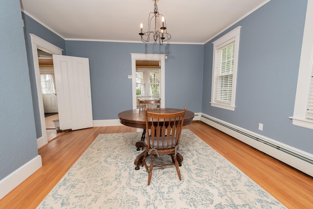 369 Ohio St, Bangor, ME 04401 - dining area featuring baseboard heating, ornamental molding, healthy amount of natural light, and a chandelier