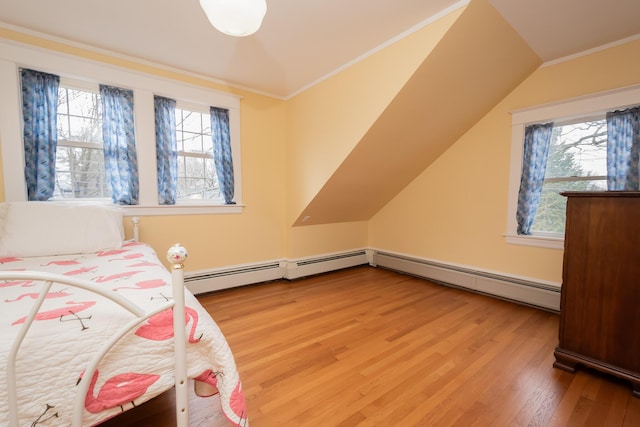369 Ohio St, Bangor, ME 04401 - bedroom featuring light wood-style floors, vaulted ceiling, a baseboard heating unit, and ornamental molding