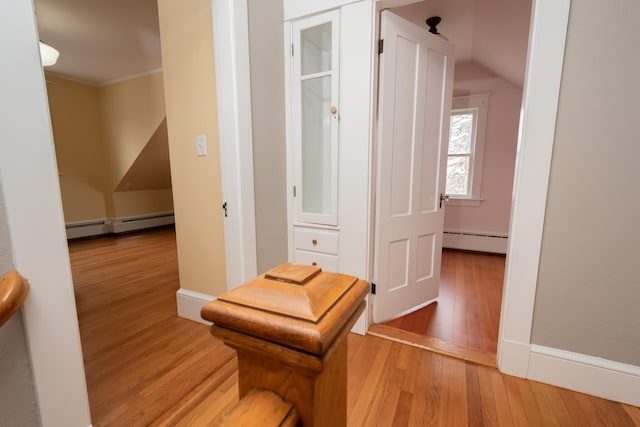 369 Ohio St, Bangor, ME 04401 - hallway with a baseboard heating unit, light wood-style floors, crown molding, and vaulted ceiling