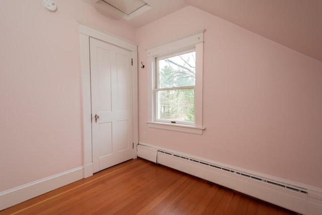 369 Ohio St, Bangor, ME 04401 - additional living space featuring baseboard heating, light wood-style flooring, lofted ceiling, and attic access