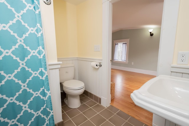 369 Ohio St, Bangor, ME 04401 - full bathroom featuring toilet, wainscoting, tile patterned floors, a sink, and a shower with curtain