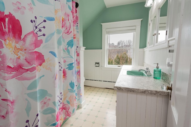 369 Ohio St, Bangor, ME 04401 - full bathroom with baseboard heating, wainscoting, tile patterned floors, vaulted ceiling, and vanity