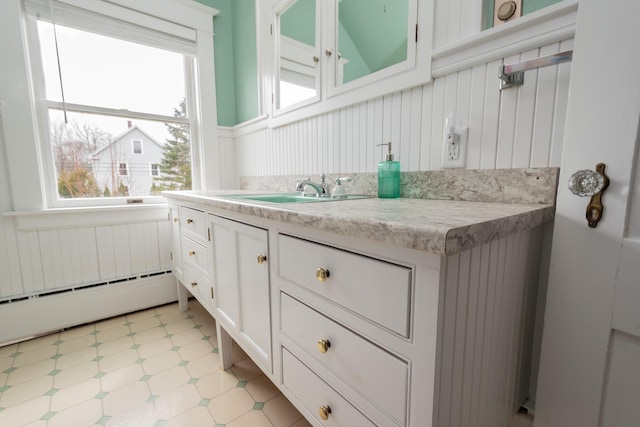 369 Ohio St, Bangor, ME 04401 - bathroom with baseboard heating, a wainscoted wall, vanity, and tile patterned floors