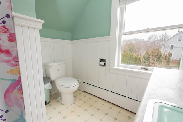 369 Ohio St, Bangor, ME 04401 - bathroom featuring baseboard heating, wainscoting, toilet, healthy amount of natural light, and lofted ceiling