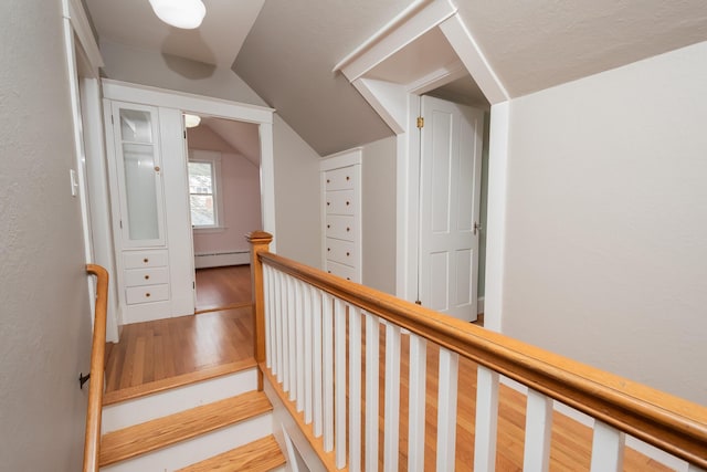 369 Ohio St, Bangor, ME 04401 - hall with wood finished floors, vaulted ceiling, an upstairs landing, and a baseboard heating unit