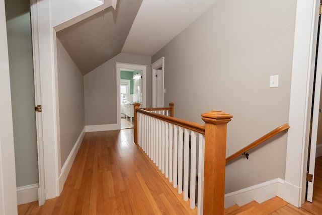 369 Ohio St, Bangor, ME 04401 - hallway with an upstairs landing, vaulted ceiling, light wood-type flooring, and baseboards