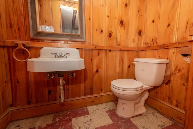 369 Ohio St, Bangor, ME 04401 - bathroom with toilet, wooden walls, a sink, and tile patterned floors
