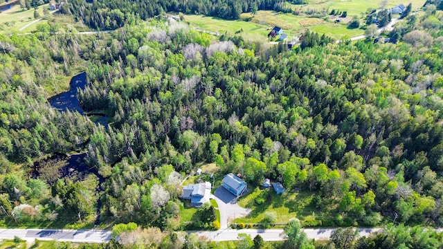 birds eye view of property with a view of trees