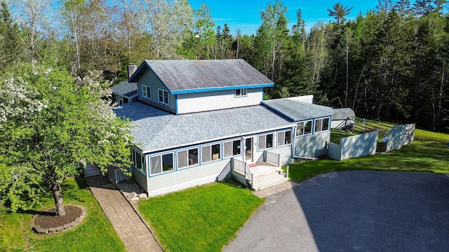exterior space featuring a wooded view