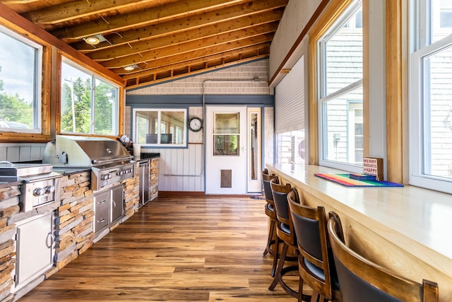 sunroom with beam ceiling and plenty of natural light