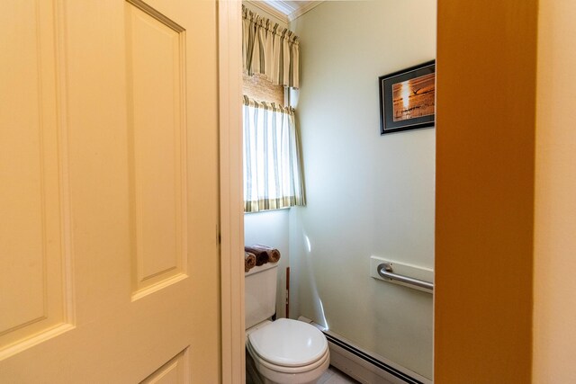 bathroom featuring ornamental molding, toilet, and a baseboard heating unit