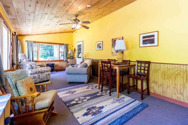 interior space featuring a wainscoted wall, wood walls, lofted ceiling, carpet, and wooden ceiling