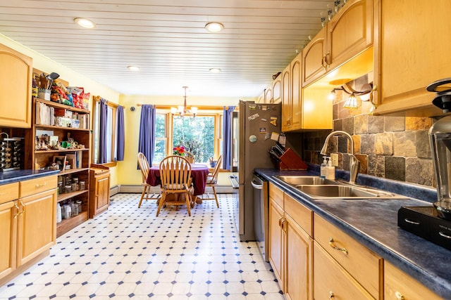 kitchen with a sink, open shelves, a chandelier, and dark countertops