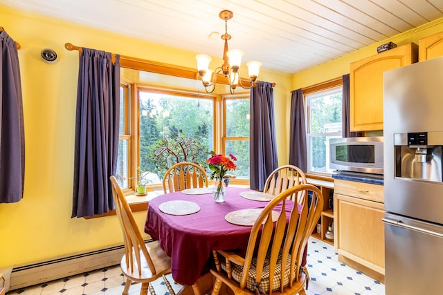 dining space featuring a wealth of natural light, an inviting chandelier, a baseboard heating unit, and light floors