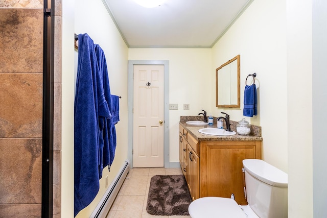 full bath with a sink, toilet, baseboard heating, crown molding, and tile patterned flooring