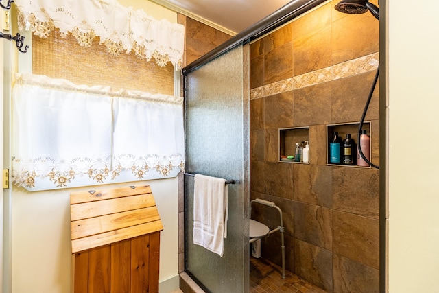 bathroom featuring ornamental molding and a stall shower