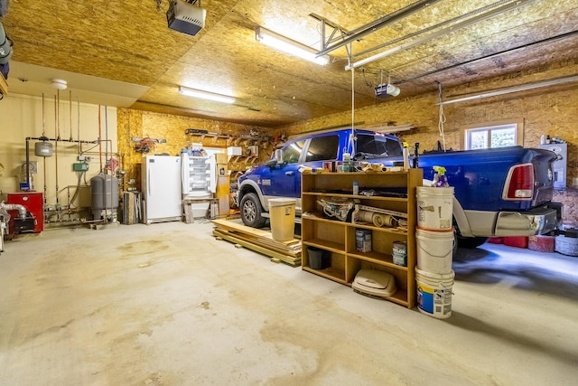 garage with freestanding refrigerator and a garage door opener