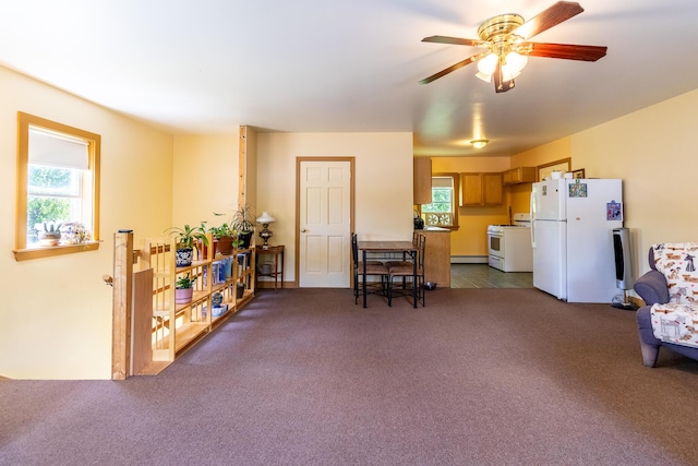interior space featuring dark carpet and ceiling fan