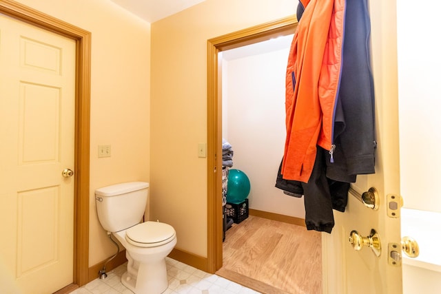 bathroom featuring tile patterned floors, baseboards, and toilet