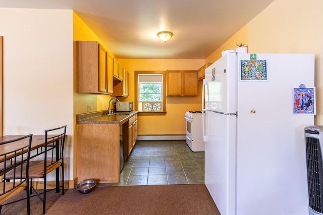 kitchen featuring white appliances, dark countertops, brown cabinets, a baseboard radiator, and a sink