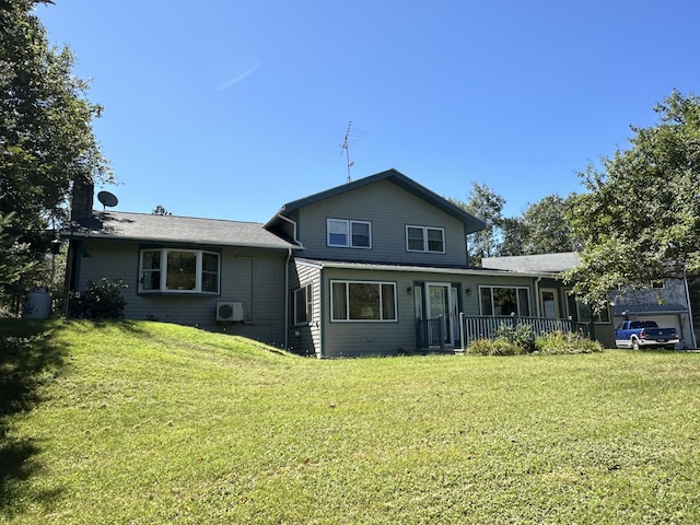 back of property with a lawn and ac unit