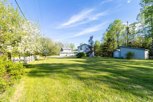 view of yard featuring an outbuilding and fence