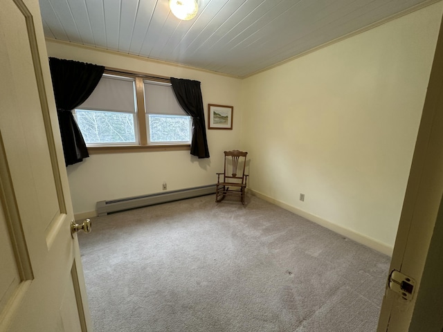 carpeted empty room with baseboards, a baseboard heating unit, and wood ceiling