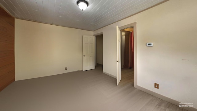 spare room with baseboards