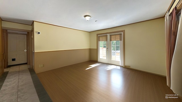 spare room featuring french doors and wood finished floors