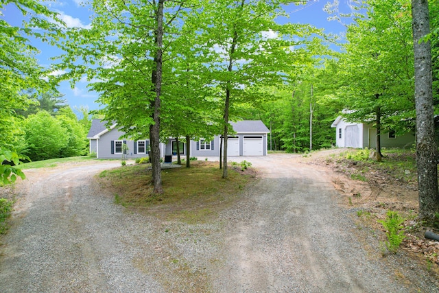 12 Charlies Way, Readfield, ME 04355 - obstructed view of property with a garage and dirt driveway