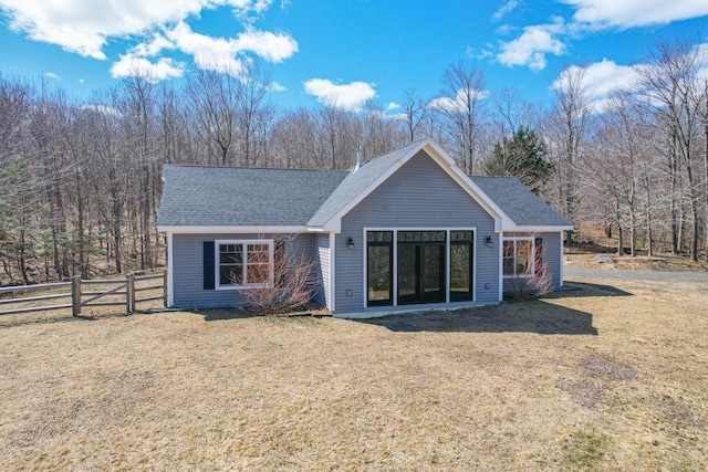 12 Charlies Way, Readfield, ME 04355 - rear view of house featuring fence, a shingled roof, and a lawn