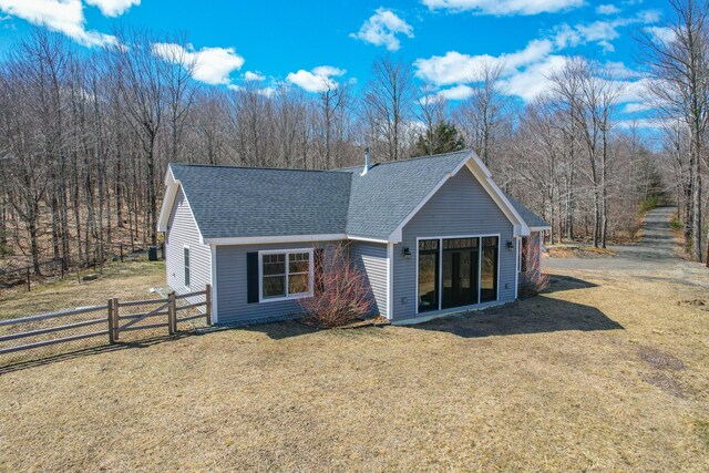 12 Charlies Way, Readfield, ME 04355 - back of property featuring fence, a shingled roof, a lawn, and french doors