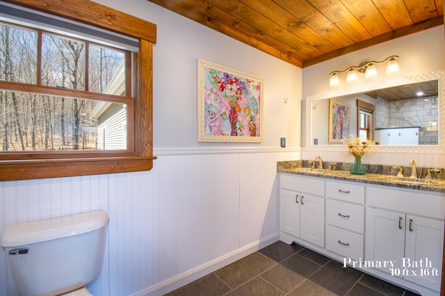 12 Charlies Way, Readfield, ME 04355 - full bathroom with double vanity, wood ceiling, tile patterned flooring, wainscoting, and a sink